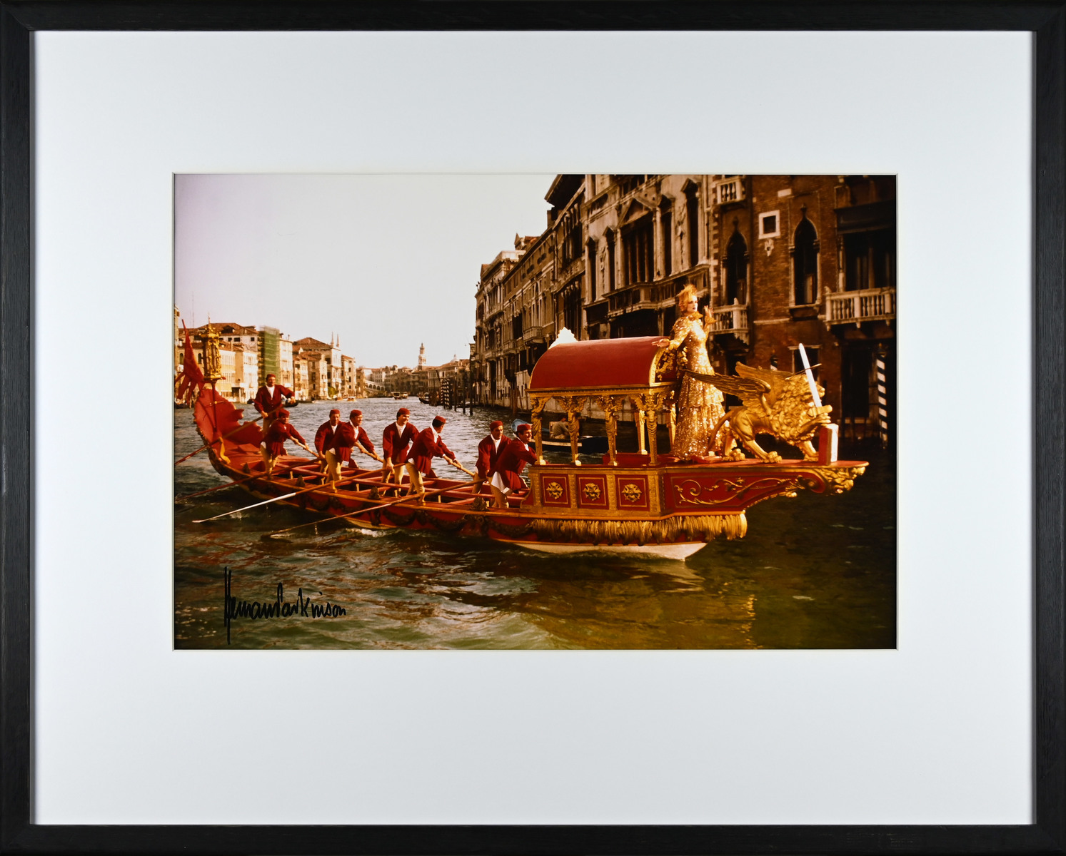 Gondola in Venice with a model in a gold dress